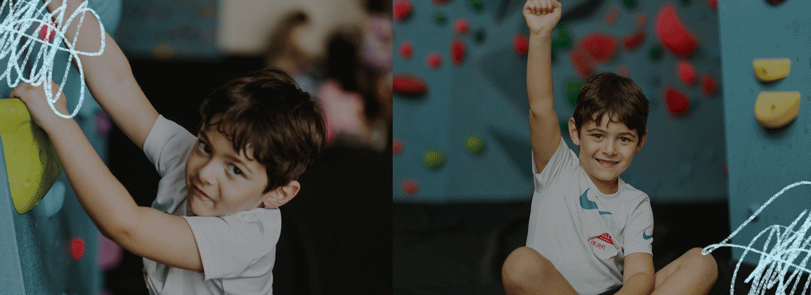 A young boy wearing a white t-shirt smiles while climbing a colorful indoor wall during his DC Summer Adventures, then raises his arm in celebration after finishing the climb.